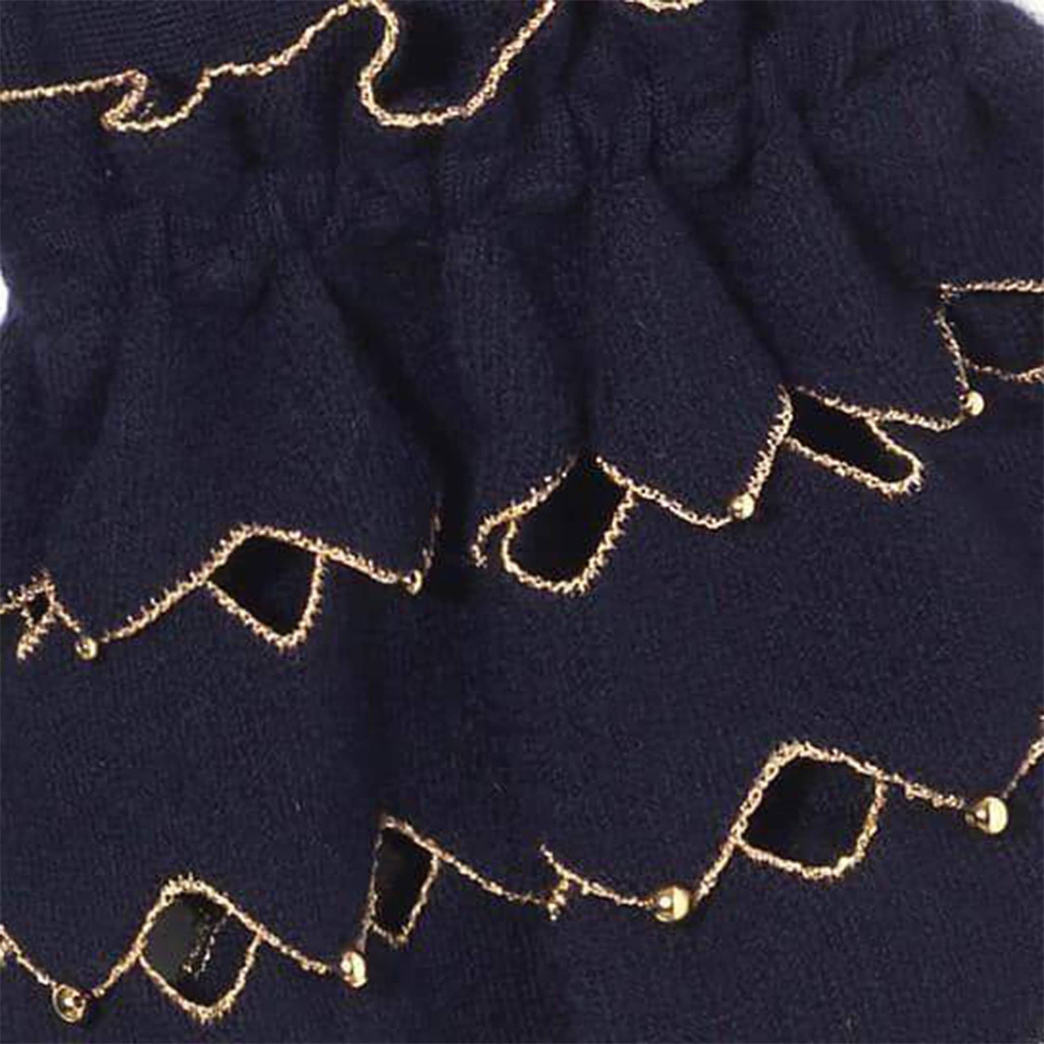Detail of navy cape / poncho, gold beads, ruffles